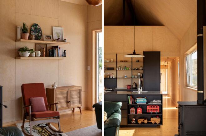 Living area with red chair and black kitchen cabinets
