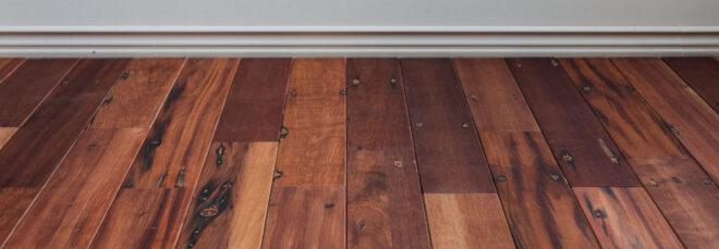 dark wood flooring against white wall