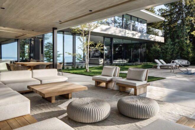 beige sofa, chairs and pouf seats on a covered outdoor patio