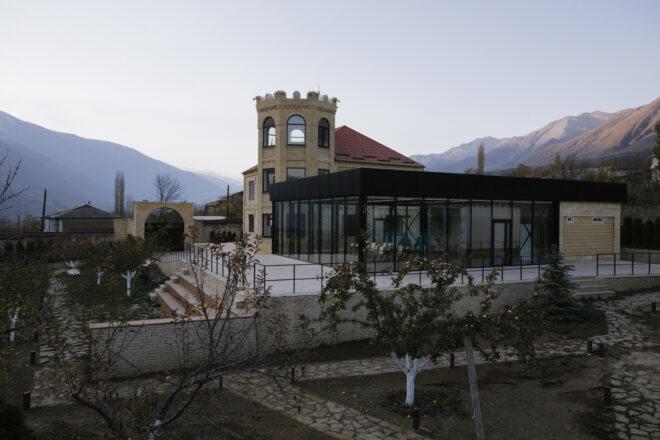 castle-like school building next to black metal and glass building