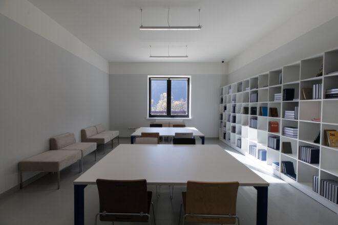 white classroom with wall of bookshelves