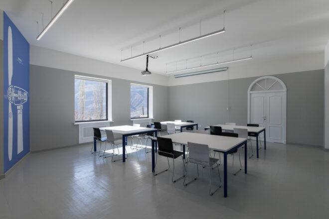 white classroom with four large white desks