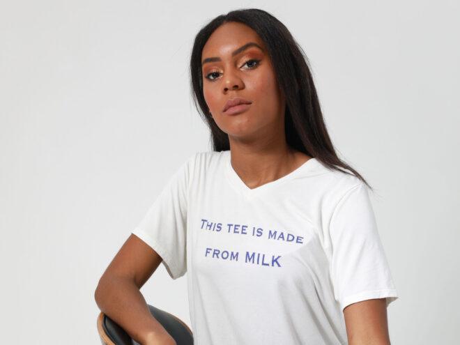 person wearing white T-shirt that reads, "This Tee Is Made From Milk"