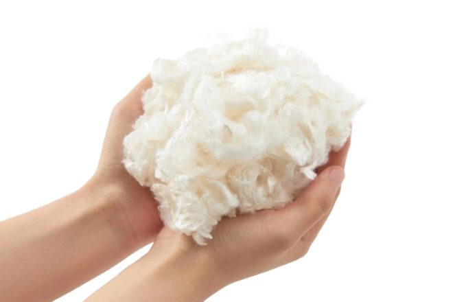 person holding yarn fibers made from old milk