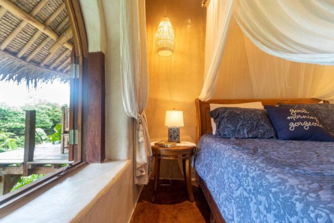 blue bed near open window