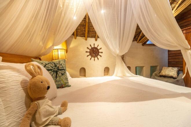 large white bed with white canopy