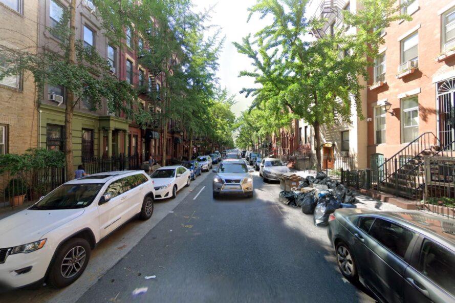 photography of cars driving down narrow street