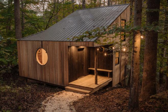 wood cabin with slanted roof and round window