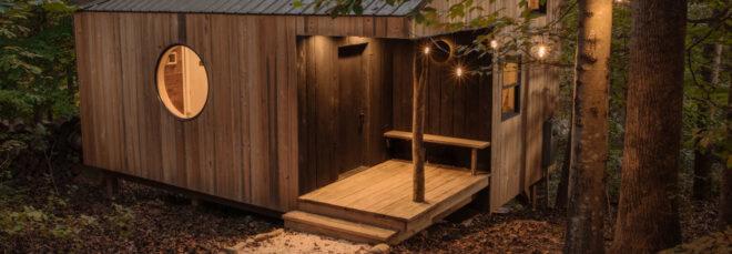 wood cabin with slanted roof and round window