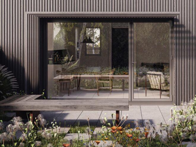 black home with glass sliding door leading to small patio