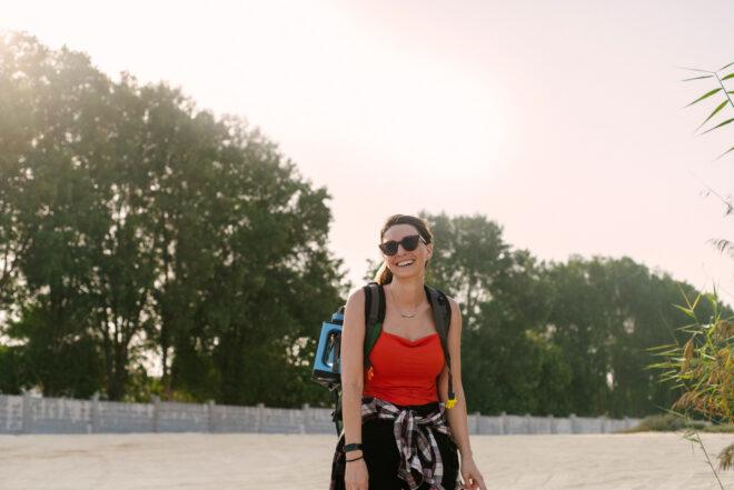 person wearing blue desalination device attached to a backpack