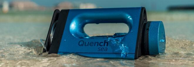 waves crashing over small blue desalination device