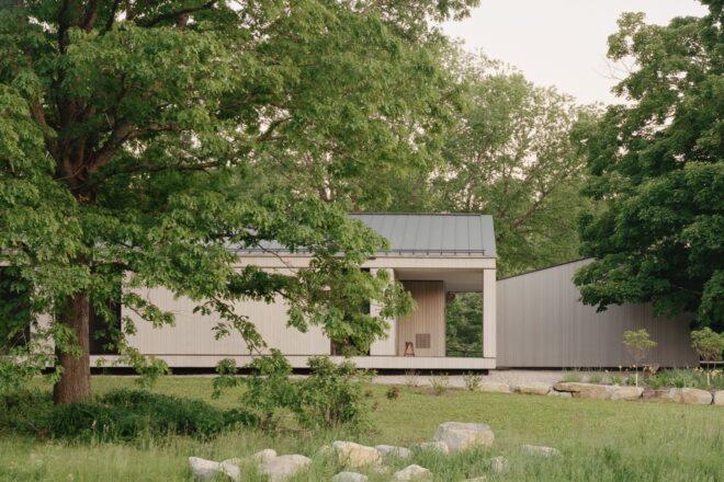 long home with light wood cladding