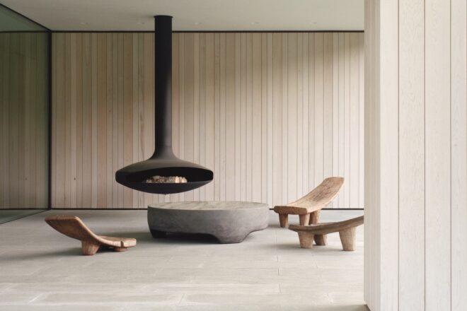 suspended fireplace with wood chairs surrounding it