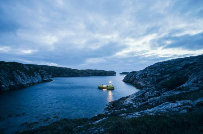 yellow boat with light on a lake