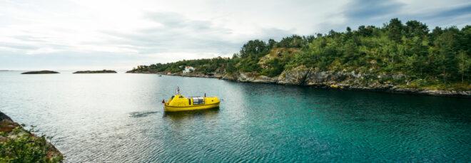 yellow boat sailing on bright blue waters