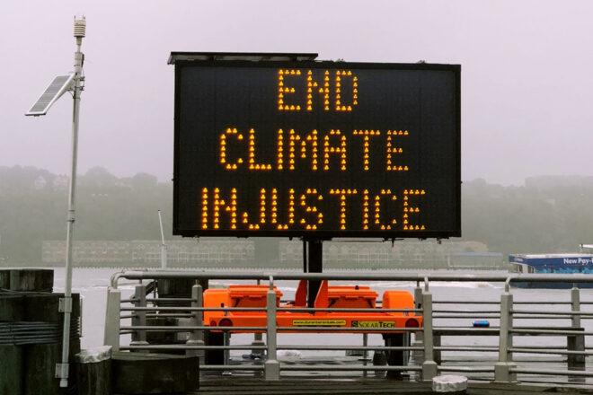 traffic sign that reads, "End Climate Injustice"
