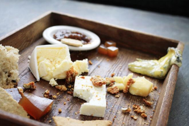 half-eaten cheese on a wood serving tray