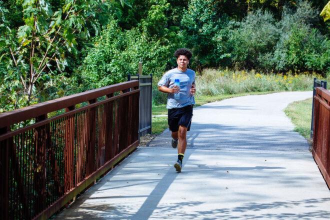 person running on a path in a park
