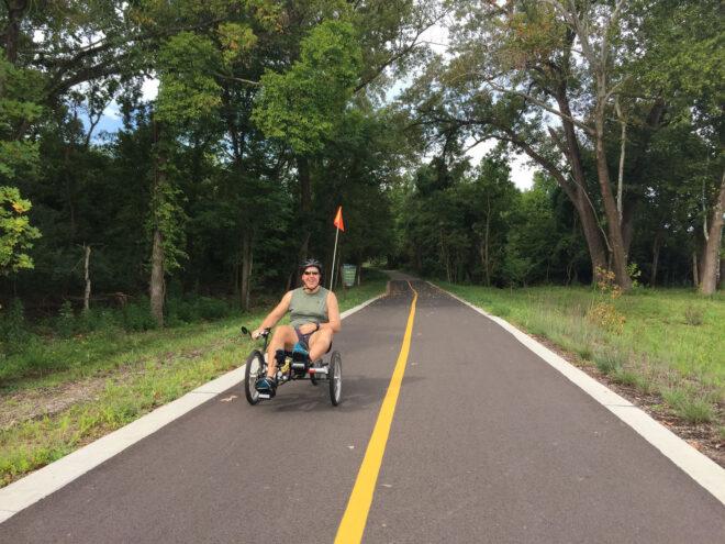 person riding bike on a trail