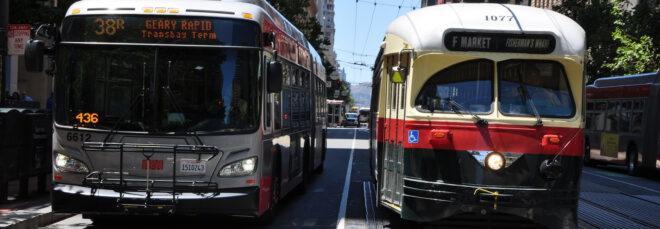 bus and tram driving side-by-side on San Francisco street