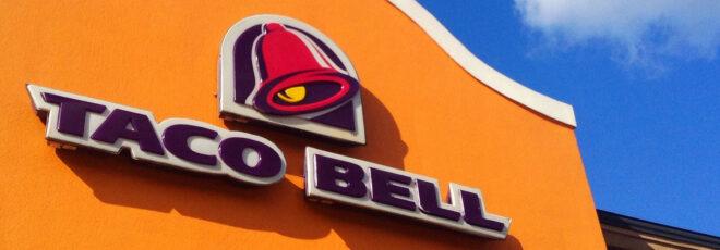 a photo of Taco Bell's logo and sign on an orange wall