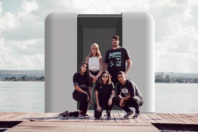 group of people in front of water transit vehicle prototype