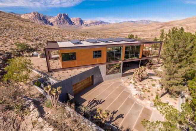 aerial view of weathered steel home topped with solar panels