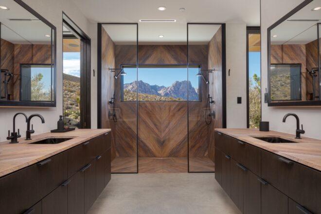 black and dark wood bathroom with glass-enclosed shower