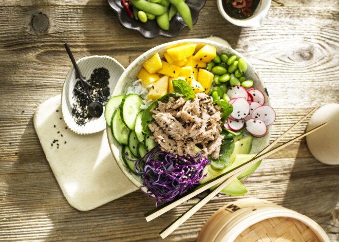 a bowl with various vegetables and a pile of vegan tuna in the middle