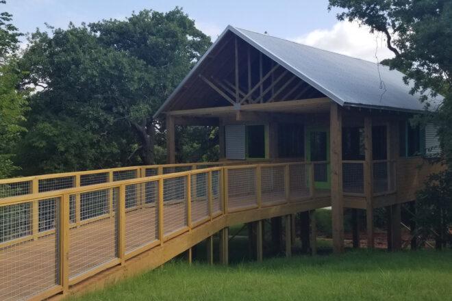 wood walkway leading to gabled building