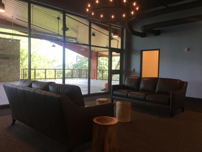 shared lounge with two sofas near a wall of glass