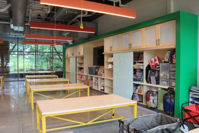 glass room with industrial style, exposed ceiling and colorful cubbies