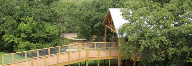aerial view of wood walkway leading to gabled building
