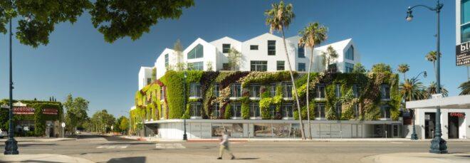 large green wall wrapping a white building with multiple gabled roofs