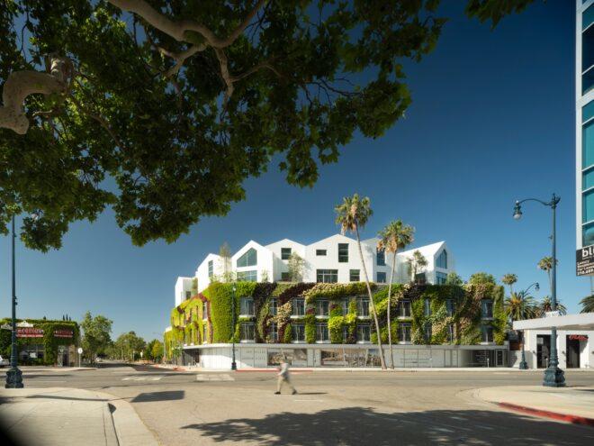 large green wall wrapping a white building with multiple gabled roofs