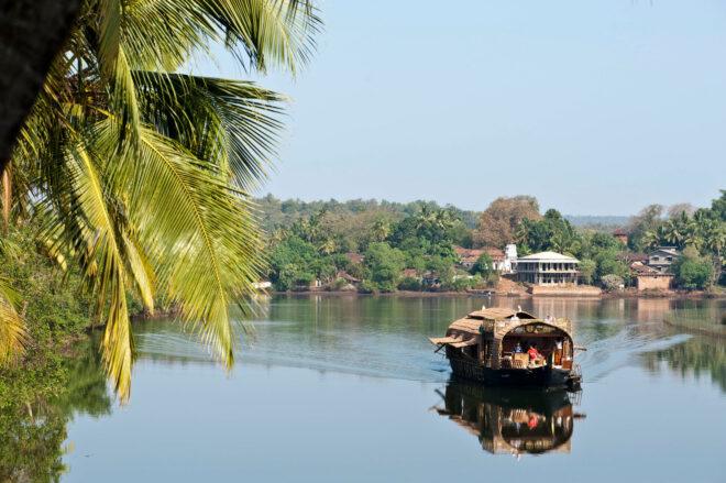 long boat with thatched roof on a river