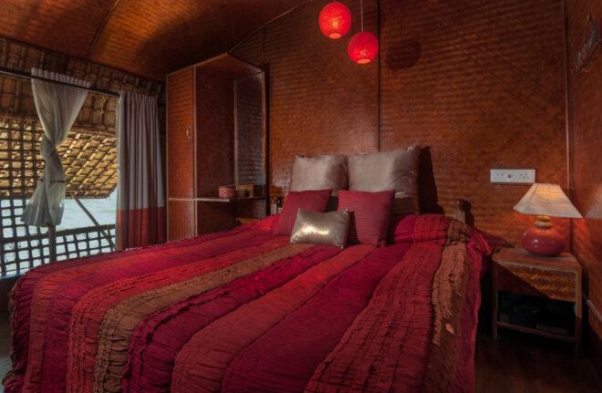 houseboat guest room with red bedding