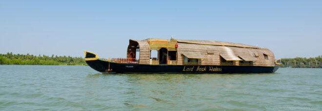 long boat with thatched roof on a river