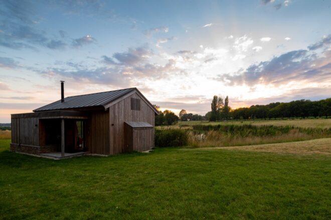 gabled wood cabin at dusk