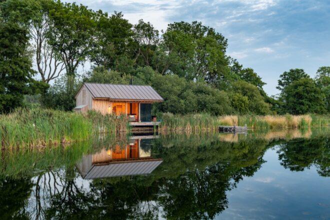small wood cabin by a lake