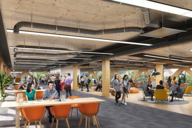 industrial office space with white tables and orange chairs