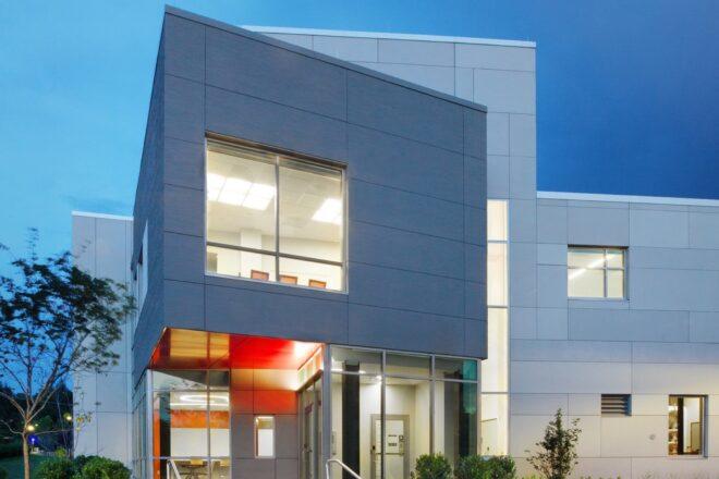 white, dark gray and orange college building at dusk
