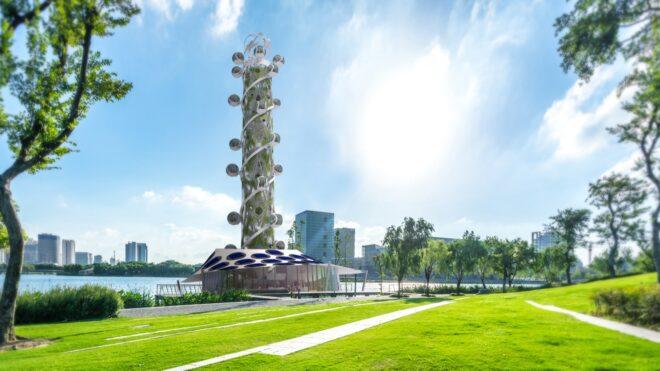 a rendering of a tall, spiral tower on a green lawn in a park. several ball-shaped capsules spiral up and down the building. toward the base of the tower is a rooftop with blue circles on it.