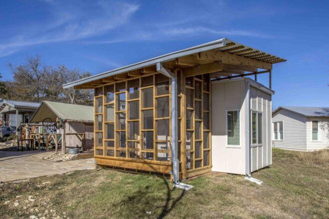 a small house with a wood frame comprised of various box frames