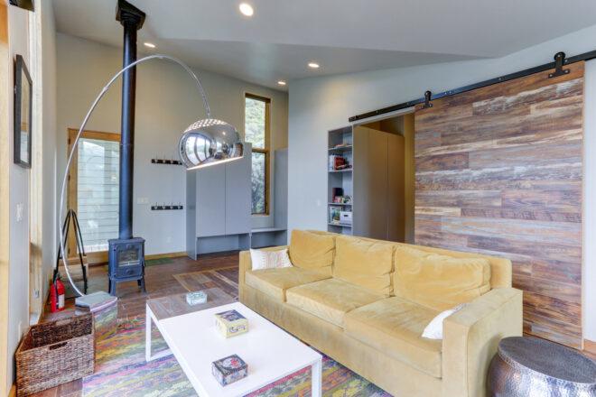 plush yellow sofa near wood-burning stove