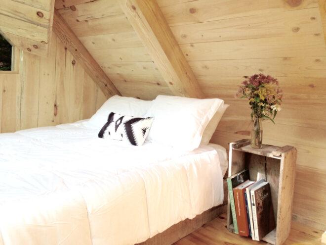 white bed in wood room