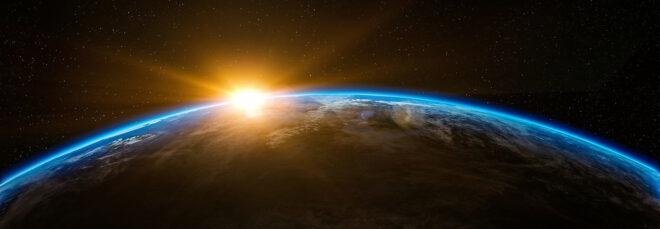 sun rising over planet Earth