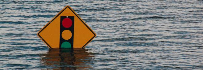 flood waters around a traffic sign