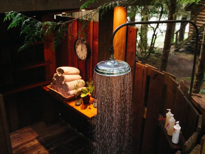 outdoor shower and spa on a wood platform